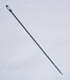 Multi-purpose needle displayed with sewing materials