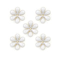 Small white enamel flower trim with brass backing.