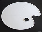 Close-up of a white kidney-shaped painting palette, showcasing its smooth surface.