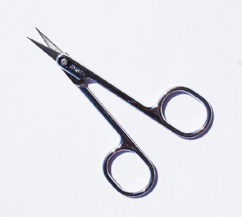 Scissors resting on a fabric surface, showcasing their precision design.
