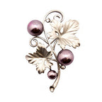 Brooch displayed on a fabric background to highlight its colour.
