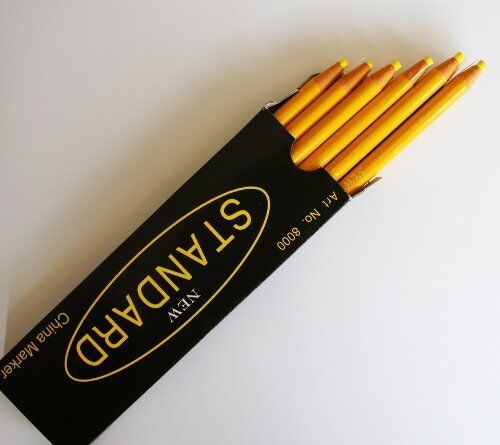 Yellow non-sharpening wax china marker pencil on a white background