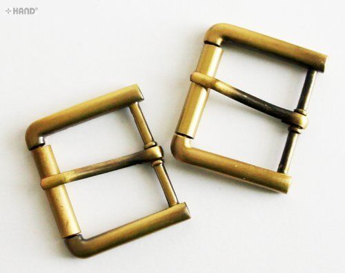 Four vintage gold tone metal buckles displayed together.