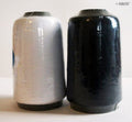 Black sewing machine thread spool, approximately 500 m.