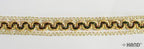 Roll of 5 metres decorative gold trim ribbon on a crafting table.