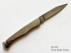 Close-up of a metal alloy folding knife with blade open