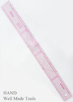Ruler laid flat on a fabric with sewing patterns