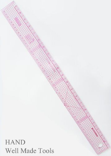 Ruler laid flat on a fabric with sewing patterns