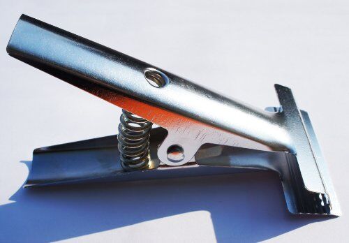 Close-up of the sprung mechanism of the fabric clamp.