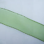 Close-up of the moss green organza trim showcasing the crochet edge