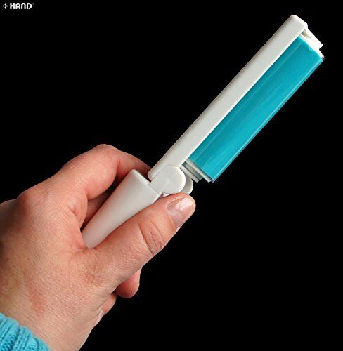 Lint roller being used on a garment to remove lint