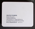 Power bank connected to a mobile phone for charging.