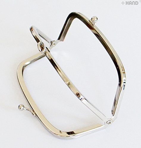 Close-up of the balls kiss clasp lock on the purse frame.