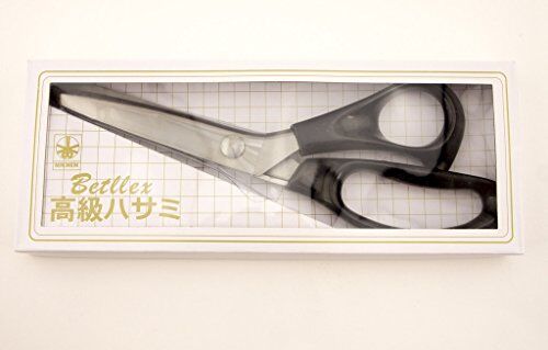 Pinking shears cutting through fabric, showcasing wave pattern.