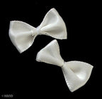 Display of white satin ribbon bows in various angles