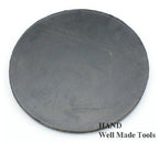 Close-up of a round black mat designed for fabric cutting applications.