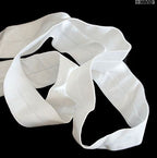 Close-up of 25mm wide off white elastic for sewing projects