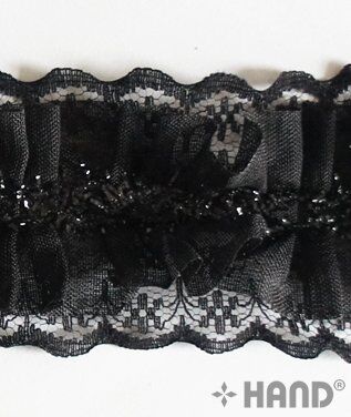Black nylon lace trim displayed with sewing tools