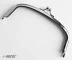 Close-up of the small ball kiss clasp on the purse frame