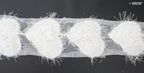 Full view of the white angel heart net trim on a flat surface