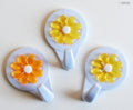 Close-up of a flower self-adhesive hook on a bathroom wall