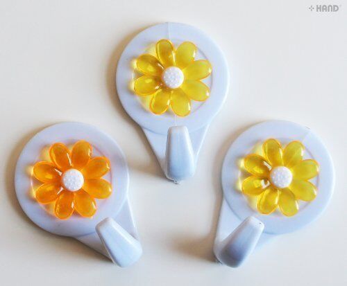Different angles of flower self-adhesive hooks on surfaces