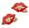 Two elegant clear crystal gold tone lips brooches displayed together.