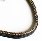 Close-up of black pipe trim showing gold edge detail