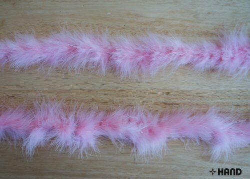 Baby pink feather garland displayed on a white background.