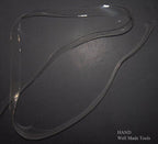 Clear flat crystal shoulder strap displayed with sewing tools