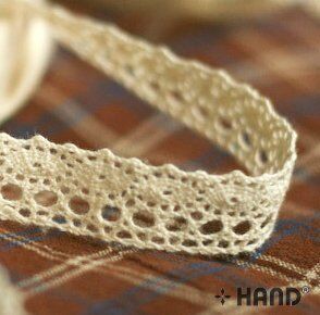 NO.4 lace trim displayed on a wooden surface
