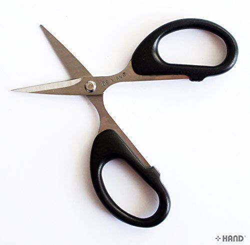 Heavy duty industrial scissors in use, cutting through fabric.