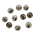 Close-up of decorative silver and white press studs.