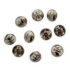 Close-up of decorative silver and white press studs.