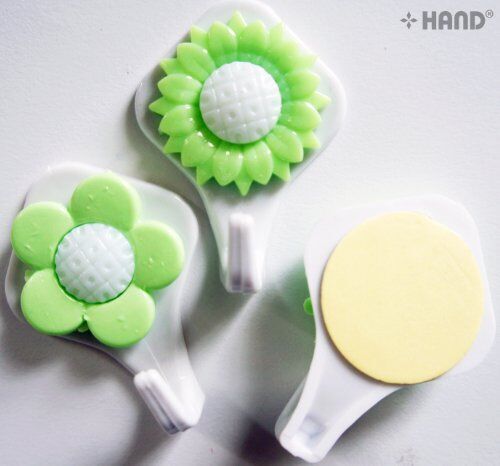 Sunflower hooks holding towels in a bathroom setting