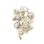 Close-up of the two leaves design on the brooch.