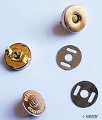 Gold magnetic buttons displayed on a white background.