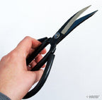 Heavy duty detail thread cutting scissors on a work surface
