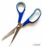 K19 scissors displayed on a craft table, highlighting their ergonomic design.