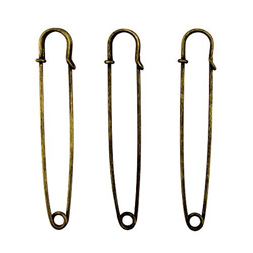 Three large gold kilt pins displayed on a white background.