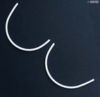 Different angles of plastic bra under wires for crafting.