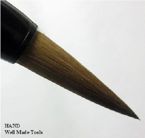 Sumi brushes in a holder with ink and paper