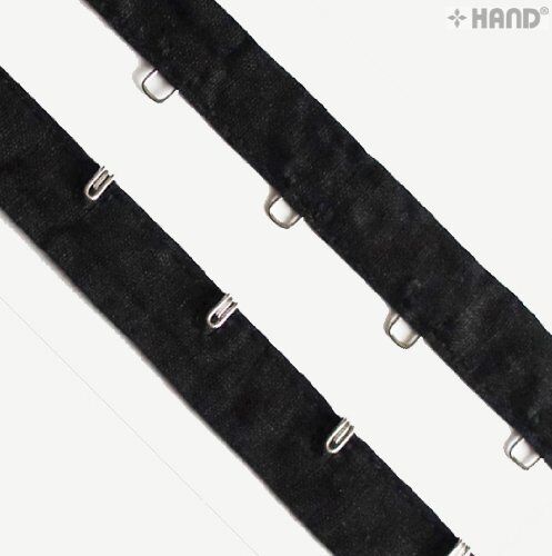 Close-up of silver hook and eyes on black tape