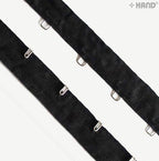 Roll of black tape with silver hook and eyes displayed