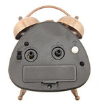 Close-up of the retro alarm clock showing the night light button.