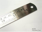 Solid steel ruler marked with metric measurements, 300mm long.