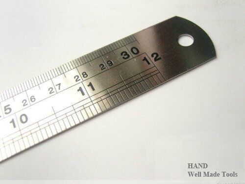 Solid steel ruler marked with metric measurements, 300mm long.