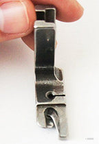 Close-up of hemming foot designed for heavy materials