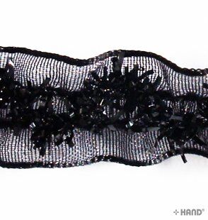 Roll of black elastic satin ribbon on a white background