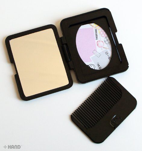 Open view of the pocket mirror showing the notebook inside.